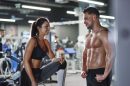 smiling-man-and-woman-talking-at-the-gym-2022-03-08-01-02-56-utc-scaled.jpg